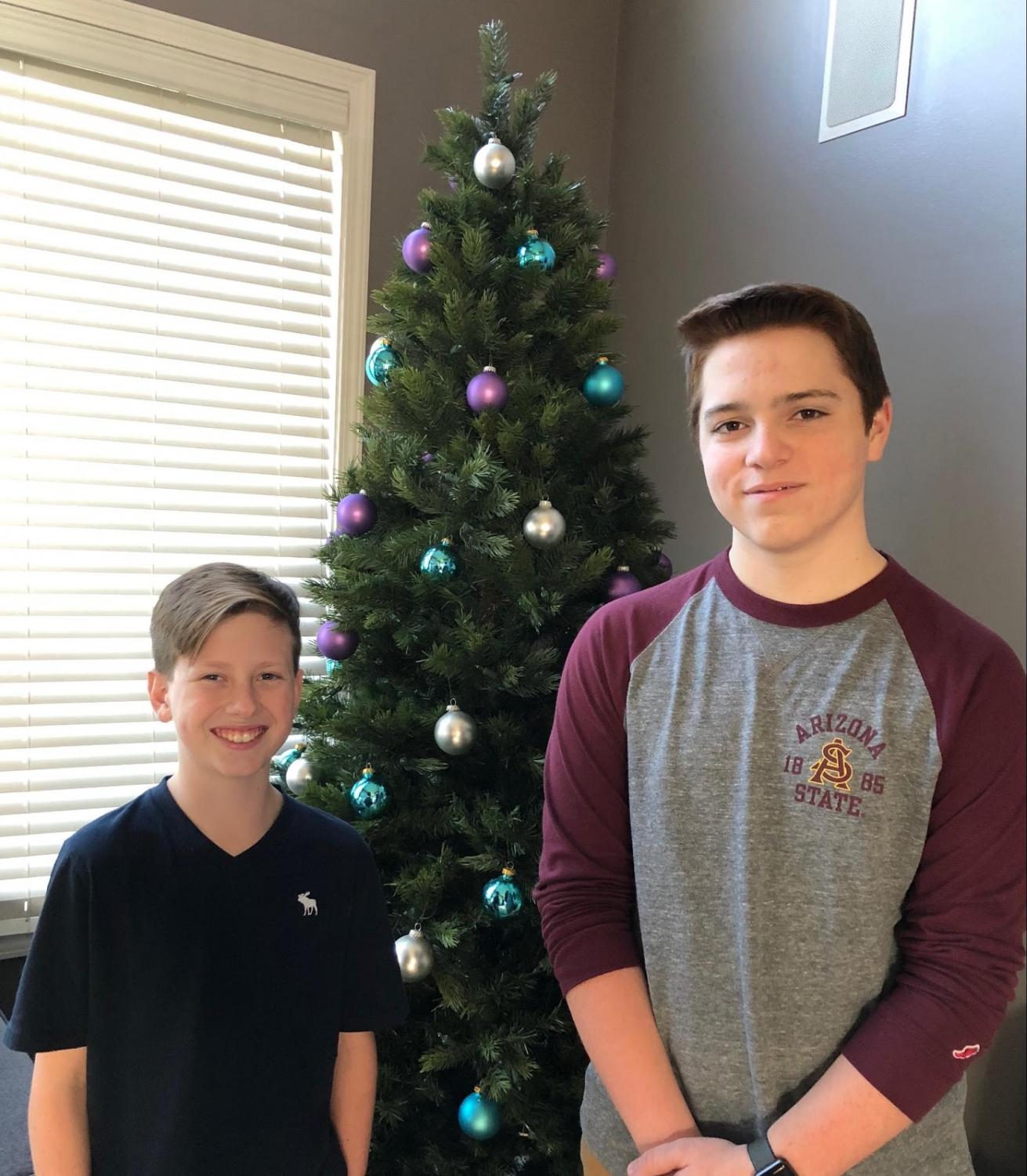 Two of The Bite reporters (7th grade), Josh Arsaro and Nate Sulak pose in front of a Christmas Tree at Nate's home.