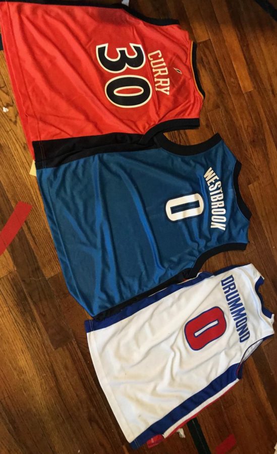Jerseys of Russell Westbrook and Stephen Curry, and Andre Drummond.