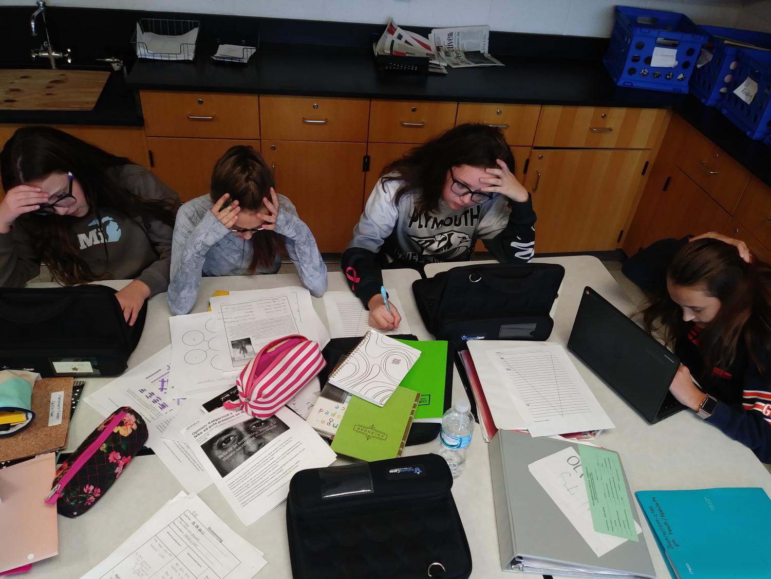 Ava Obrock, Olivia Stults, Viviana Buzzelli, and Caitlyn Blasch work on homework during the school day.