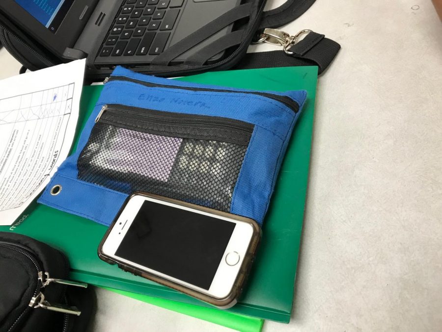 A phone on a desk during class. 