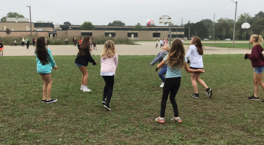 West 6th graders playing volleyball at recess.