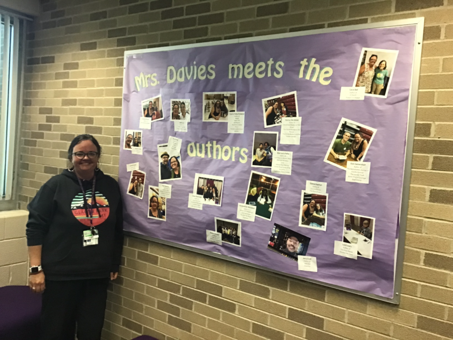 Mrs. Davies posing by her poster.